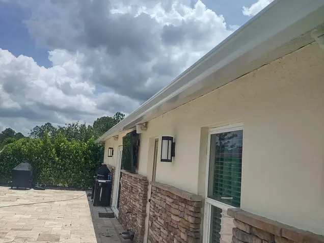 Modern outdoor patio featuring durable insulated aluminum panels, installed by AlumiPro, providing shade and energy efficiency by the poolside.